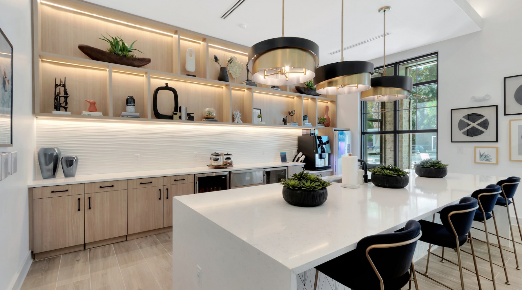 Clubhouse kitchen with large waterfall island and bar stools