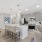 kitchen with grey cabinets and white granite and island