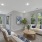 living space with white sofas, coffee table and large windows
