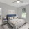 Secondary bedroom with queen bed opening up to living room