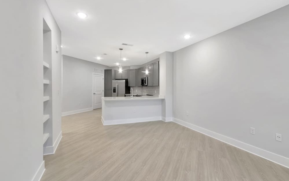 living room on wood-style flooring and with easy access to the kitchen area