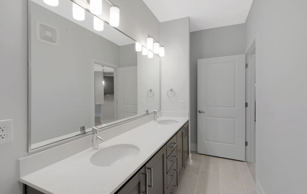 bathroom area with a mirror and ample counter-space
