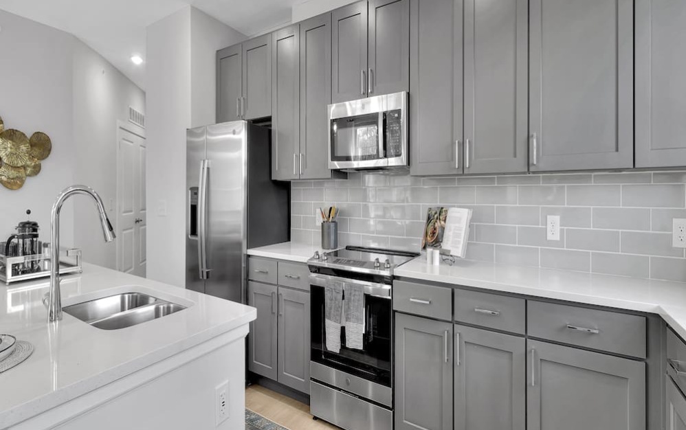 kitchen with wooden backsplash, ample counter-space and easy to access island