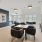 Lounge area with blue accent wall and multiple tables/chairs