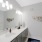 Primary Bathroom with wall decor, single sink and long vanity with grey cabinets