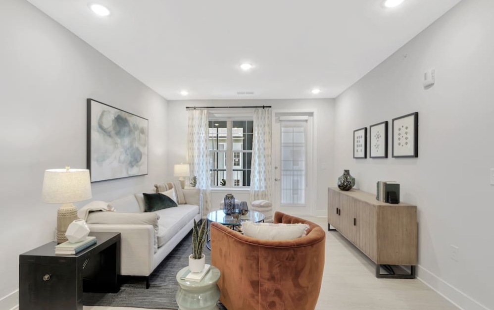 living room with plenty of space for couches, with bright lighting from multiple windows