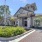 Outside of clubhouse, neutral tones and well manicured landscaping