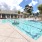 Spacious sparkling pool with sundecks and cabanas for lounging.