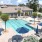 Spacious sparkling pool with sundecks and cabanas for lounging.